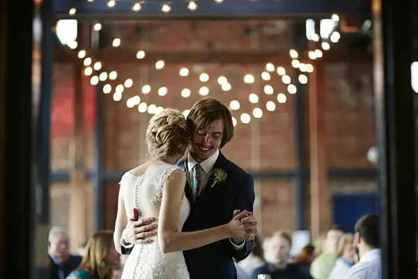 Bride and groom first dance at industrial-chic Seattle-area wedding venue. Lovely Events.